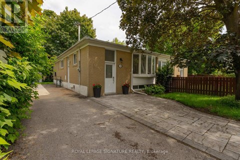 A small house with a driveway in front of it.