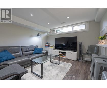 A living room with a grey sofa and a glass coffee table.