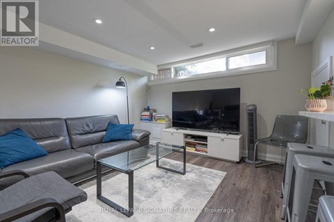A living room with a grey sofa and a glass coffee table.