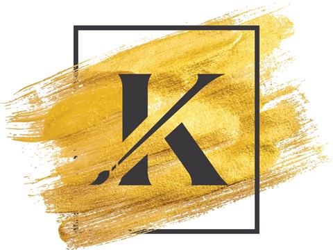 A black and white image of the letter K on a gold brush stroke background.
