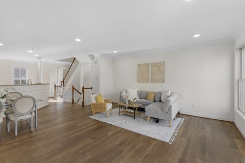 A living room with a grey couch and a yellow chair.