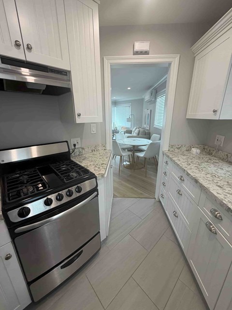 A kitchen with a stove and a counter.