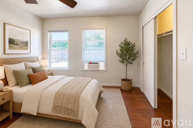 A bedroom with a large bed and a ceiling fan.