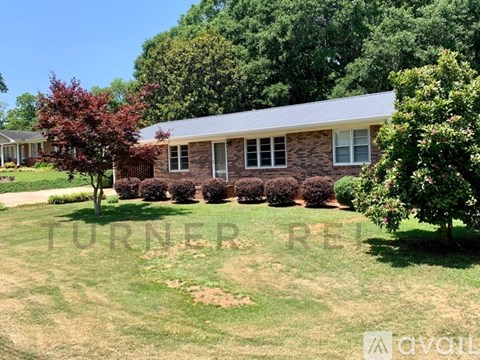 A house with a lawn in front of it.