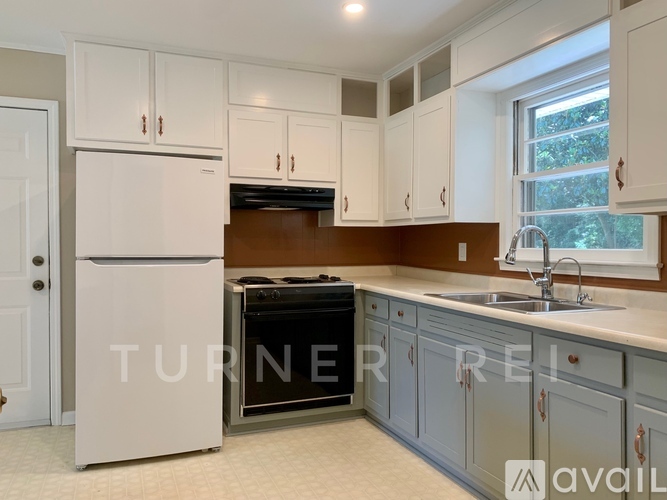 A kitchen with a white refrigerator and a stove top oven.