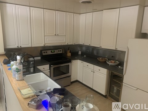 A kitchen with white cabinets and a black stove top.