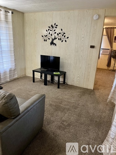 A living room with a television and a couch.