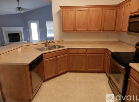 A kitchen with wooden cabinets and a beige countertop.