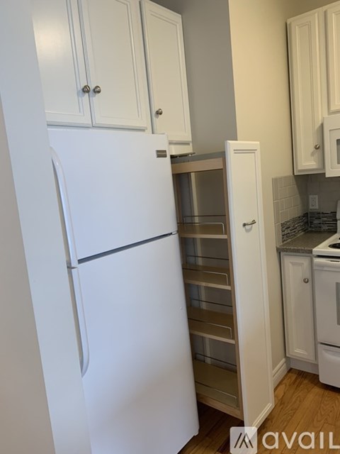 A white refrigerator with its door open in a kitchen.