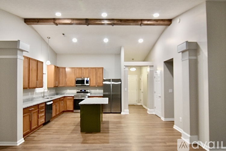 A kitchen with wooden cabinets and a central island.