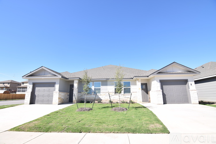 A house with a clear blue sky above it.