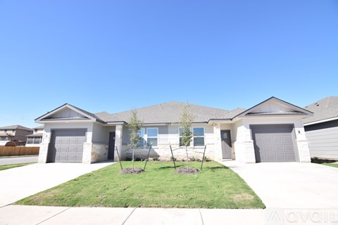A house with a clear blue sky above it.