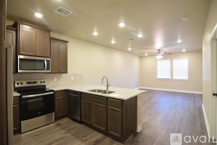 A kitchen with wooden cabinets and stainless steel appliances.