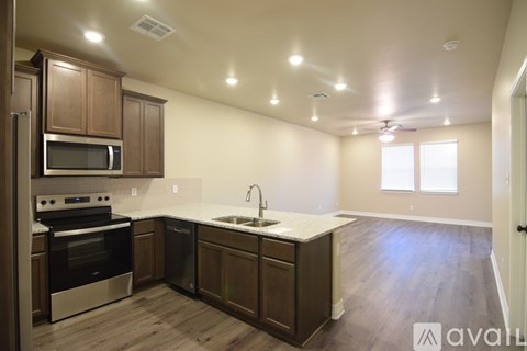 A kitchen with wooden cabinets and stainless steel appliances.