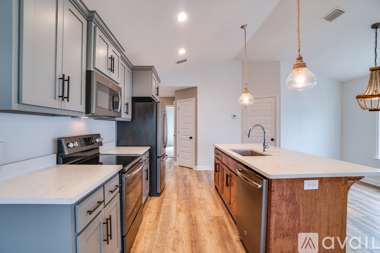 A kitchen with wooden cabinets and a white countertop.