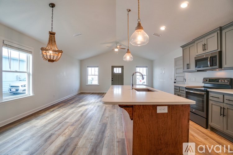 A kitchen with a wooden island in the middle of the room.
