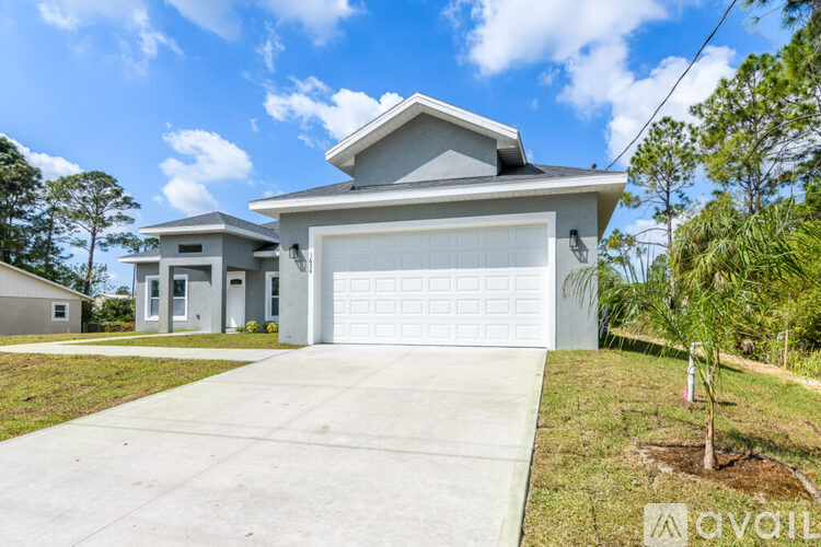 A two-story house with a garage is available for sale.