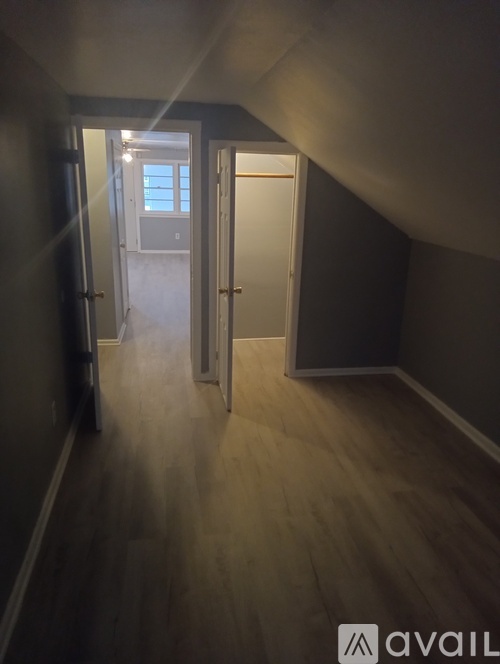 A hallway with a door at the end.
