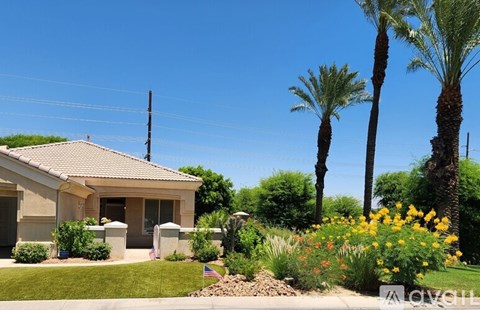 A house with a garden in front of it.