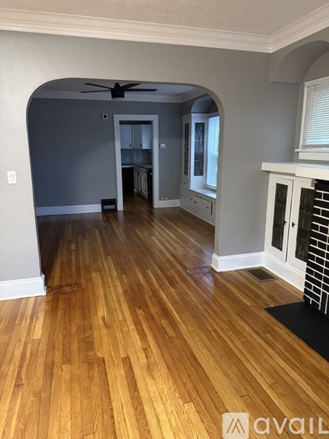 A room with wooden floors and a fireplace.