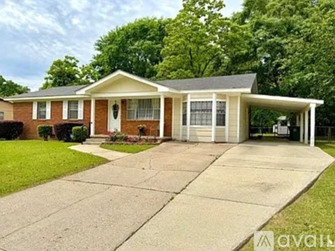 A house with a front yard and a driveway.