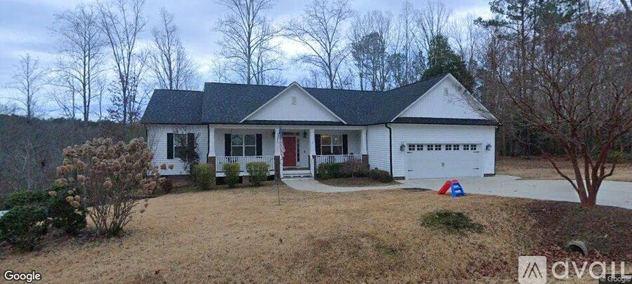 A white house with a red door is for sale.