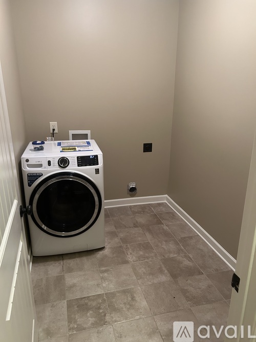 A small laundry room with a washer and dryer.