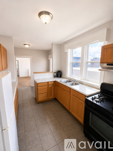 A kitchen with wooden cabinets and a white refrigerator.