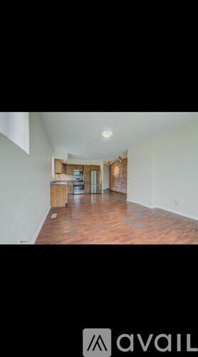 A room with wooden floors and a white wall.