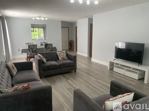 A living room with grey couches and a television.
