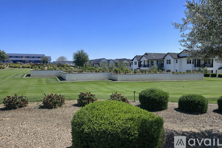 A row of houses with a grassy area in front.