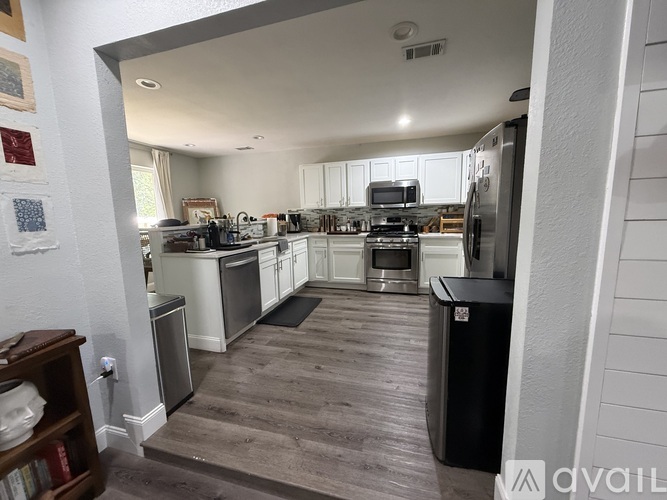 A kitchen with white cabinets and stainless steel appliances.