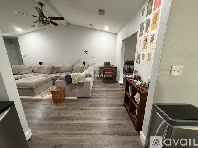 A living room with a grey sofa and a wooden coffee table.