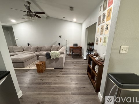 A living room with a grey sofa and a wooden coffee table.