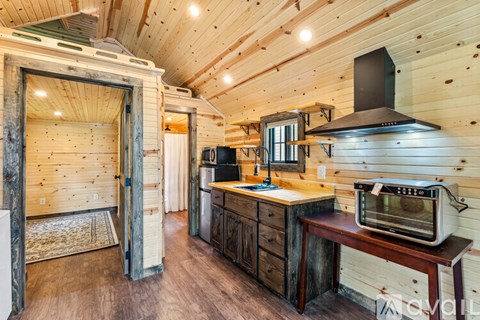A small kitchen with a microwave and oven on a counter.