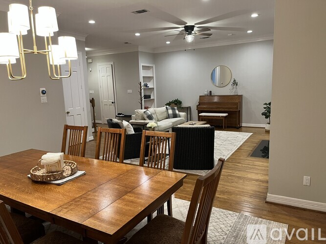 A dining room with a wooden table and chairs.