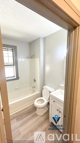 A bathroom with a toilet, sink and bathtub.