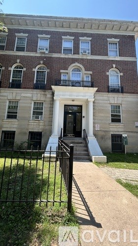 A brick building with a white door and windows.