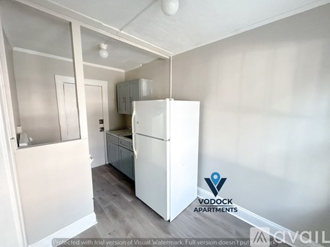 A Vodock Apartments logo is on a wall in a kitchen.