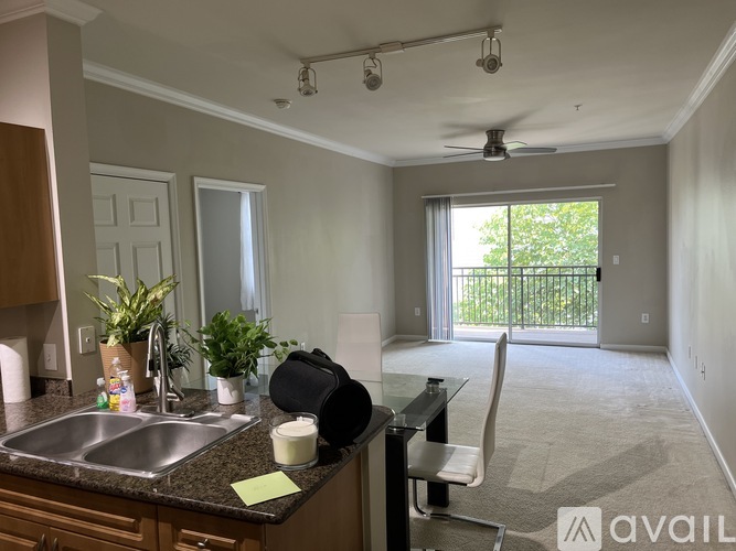 A kitchen with a sink, a window, and a fan.