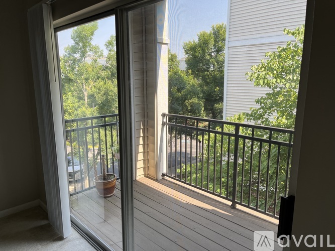 A balcony with a glass door leading to a patio.