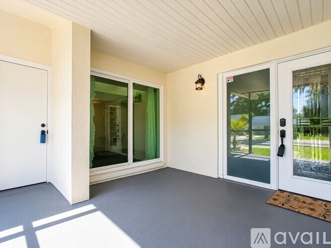 A room with a white door and a glass window.