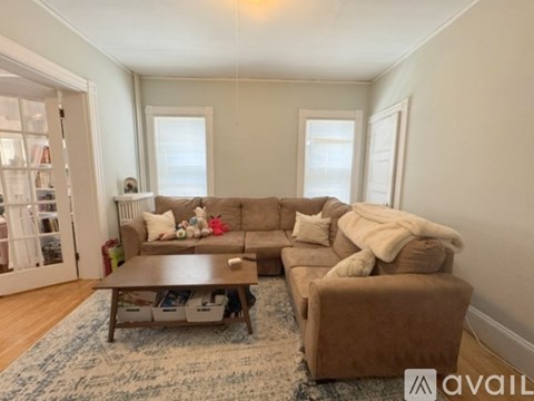 A living room with a brown couch and a coffee table.