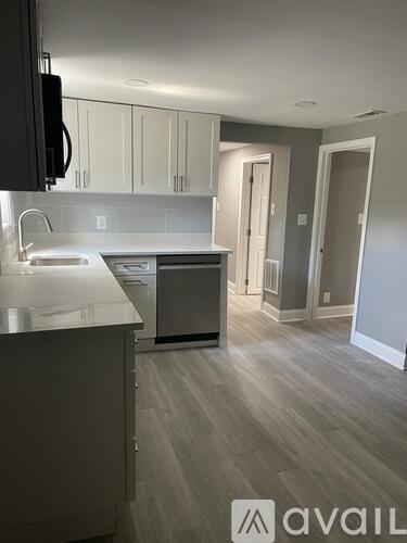 A kitchen with a sink and cabinets.