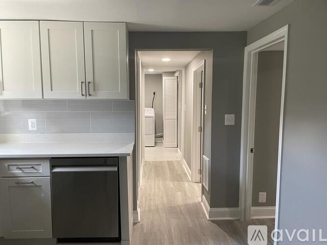 A kitchen with a dishwasher and cabinets.