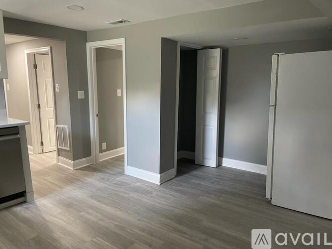 A room with grey walls and a wooden floor.