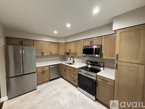 A kitchen with wooden cabinets and stainless steel appliances.