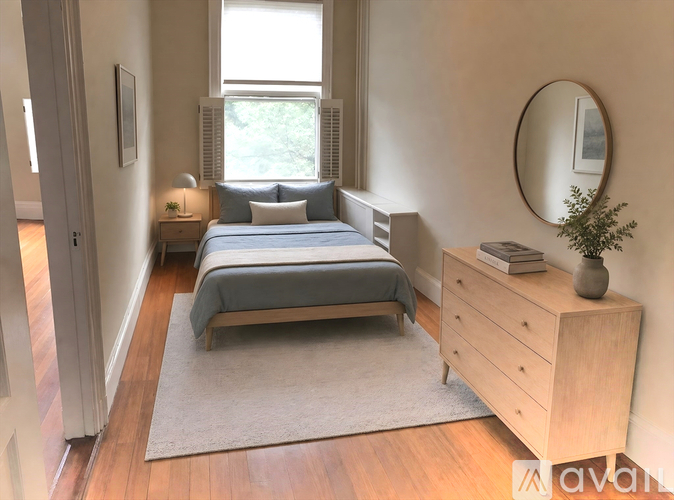 A bedroom with a bed, nightstand, and dresser.