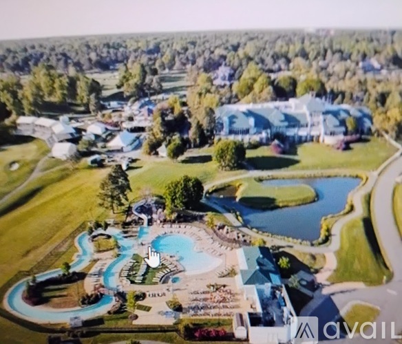 A bird's eye view of a resort with a pool and a lake.