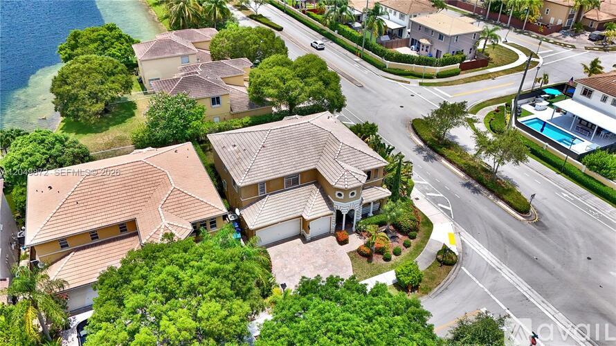 A bird's eye view of a residential area with houses and a swimming pool.